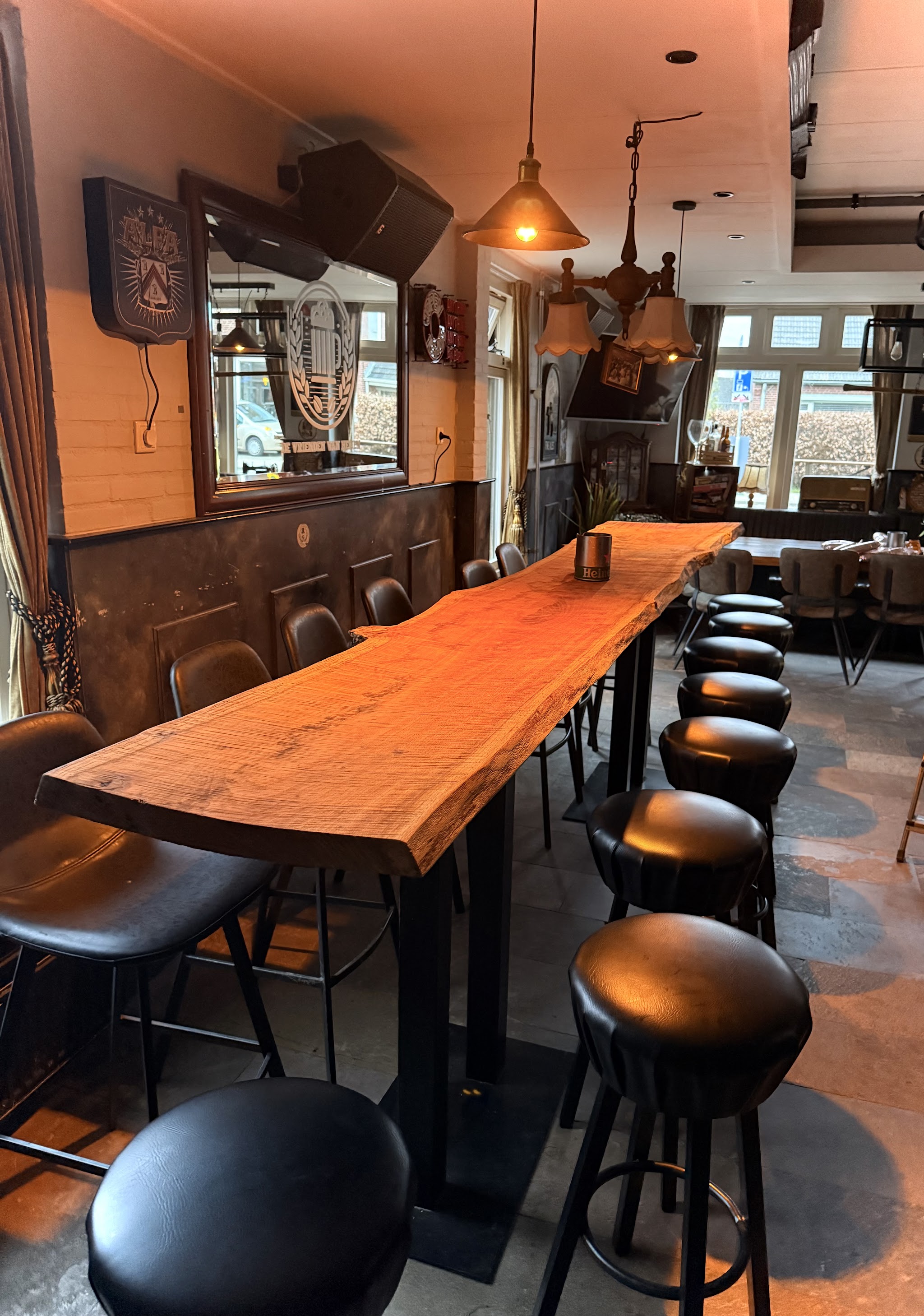 De lange houten bartafel overdag, met de kroonluchter erboven